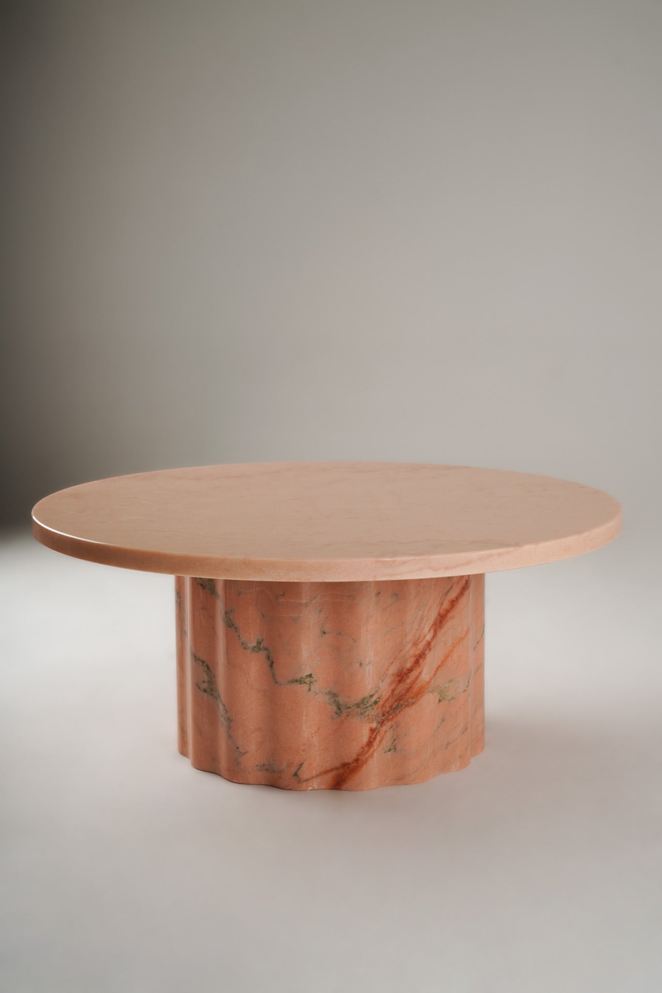 Stine Coffee Table 01 – round Rosa Aurora marble table with sculptural wavy base, front view