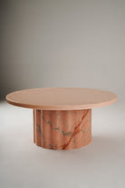 Stine Coffee Table 01 – round Rosa Aurora marble table with sculptural wavy base, front view
