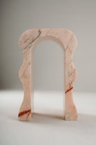 Stine Stool 01 in Rosa Aurora marble – curved sculptural legs, front view