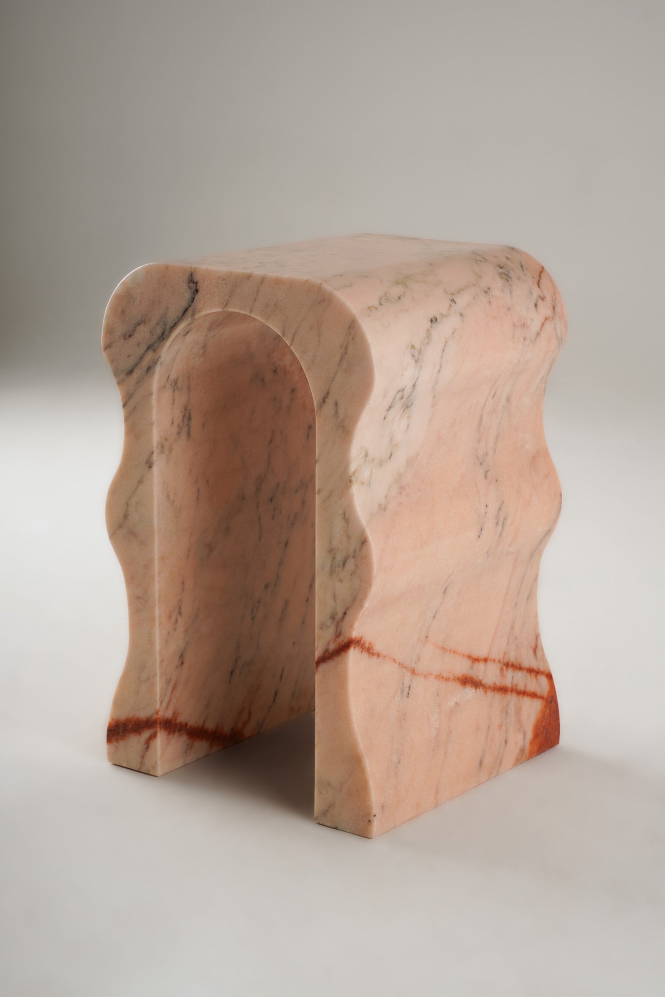 Stine Stool 01 in Rosa Aurora marble – curved sculptural legs, full product view